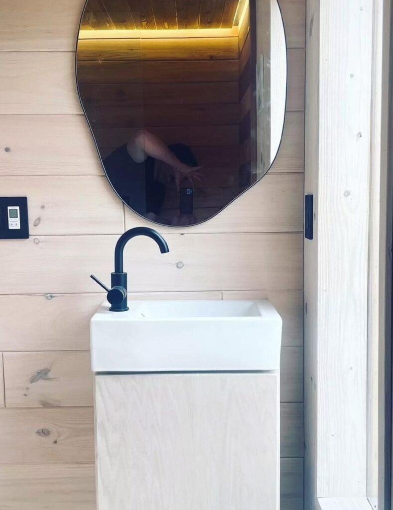 Exterior view of Weekender house with large windows and metal cladding