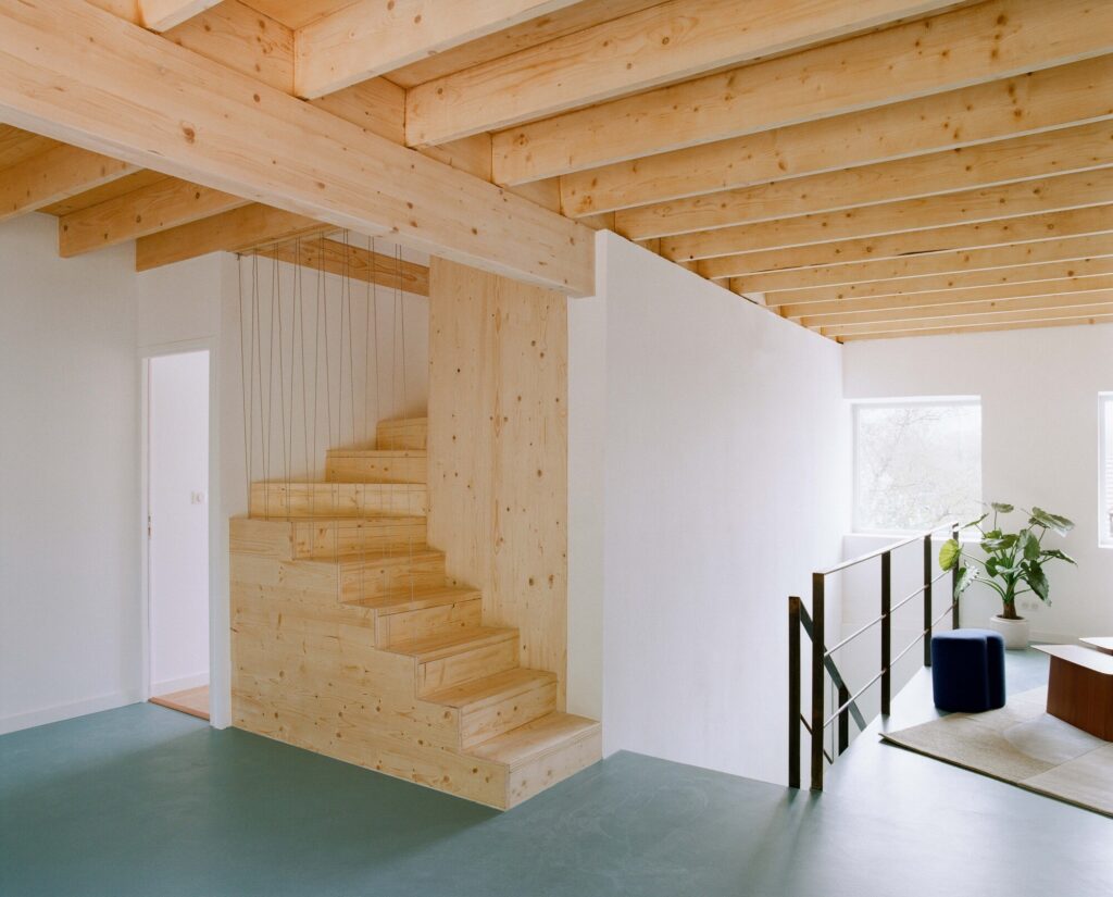 Comprehensive view of the renovated 1980s house showing sustainable upgrades, improved energy efficiency, open interior spaces, and enhanced natural lighting and ventilation