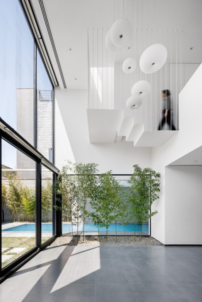 Villa 13 showcasing spatial interaction between open, semi-open, and enclosed areas, central green courtyard, sunlight orientation, and layered shading strategies enhancing interior and exterior experience