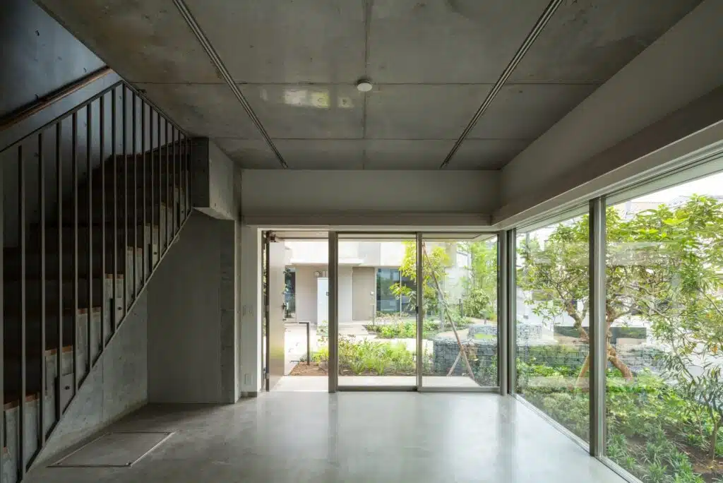 Overview of Nishi-Ogikubo residential cluster showing three-story terraced houses and narrow garden paths.