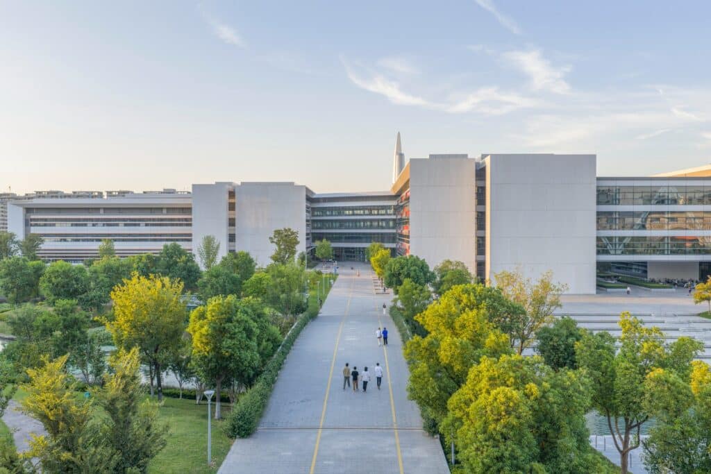 Aerial view of West Lake University campus showing interconnected academic and residential buildings surrounded by greenery.