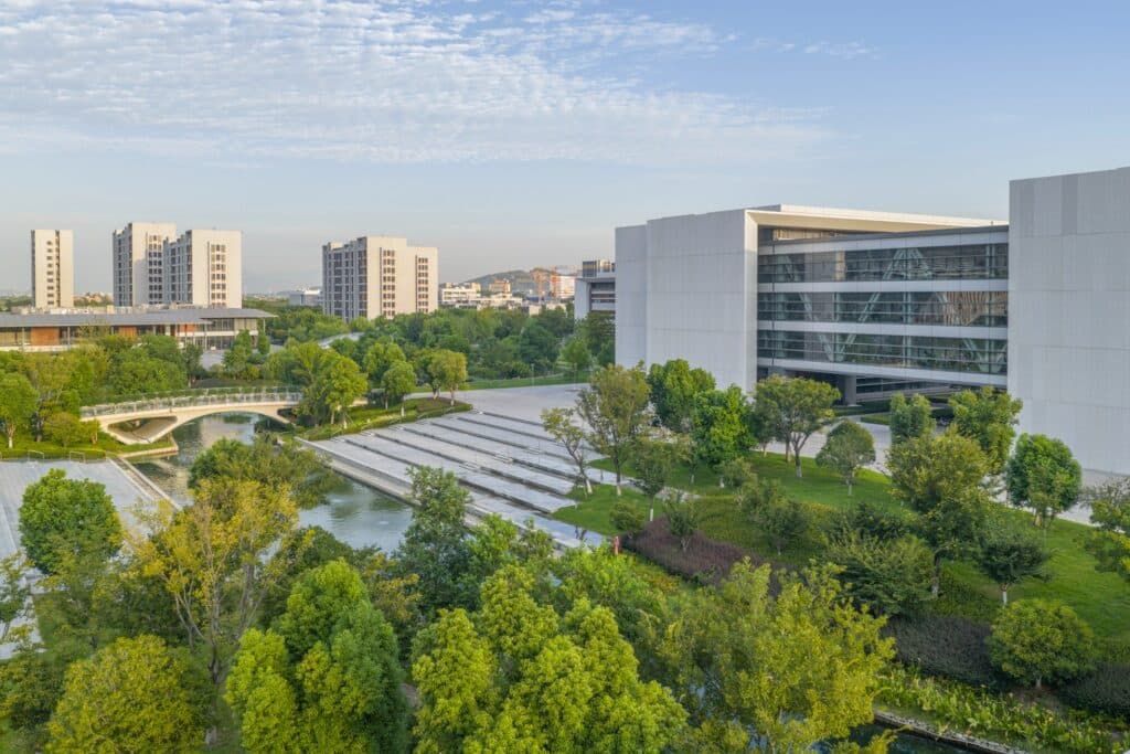 Aerial view of West Lake University campus showing interconnected academic and residential buildings surrounded by greenery.