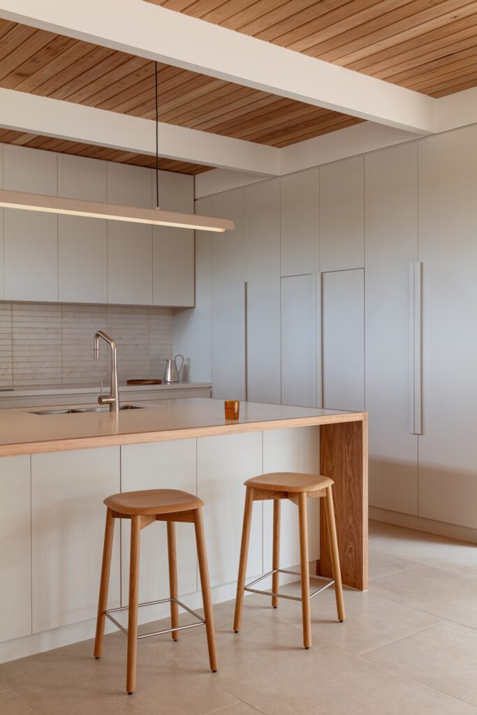 Open living spaces in Anglesea house flowing seamlessly towards the garden, enhancing indoor-outdoor connection.