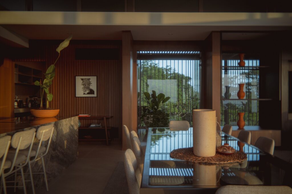 Comprehensive view of Nuri Villa showcasing modern architectural design, seamless integration of indoor and outdoor spaces, green terraces, suspended pool, natural materials, cultural interior details, panoramic ocean views, sustainable construction, and immersive living experience connecting nature, architecture, and local culture.