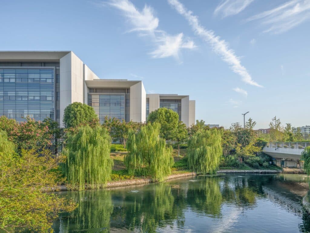 Modular academic buildings at West Lake University featuring linear structures with distinct facade patterns and colors.