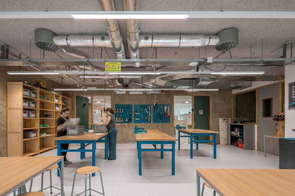 Interior shared learning spaces designed to encourage interaction and social engagement among students and teachers.