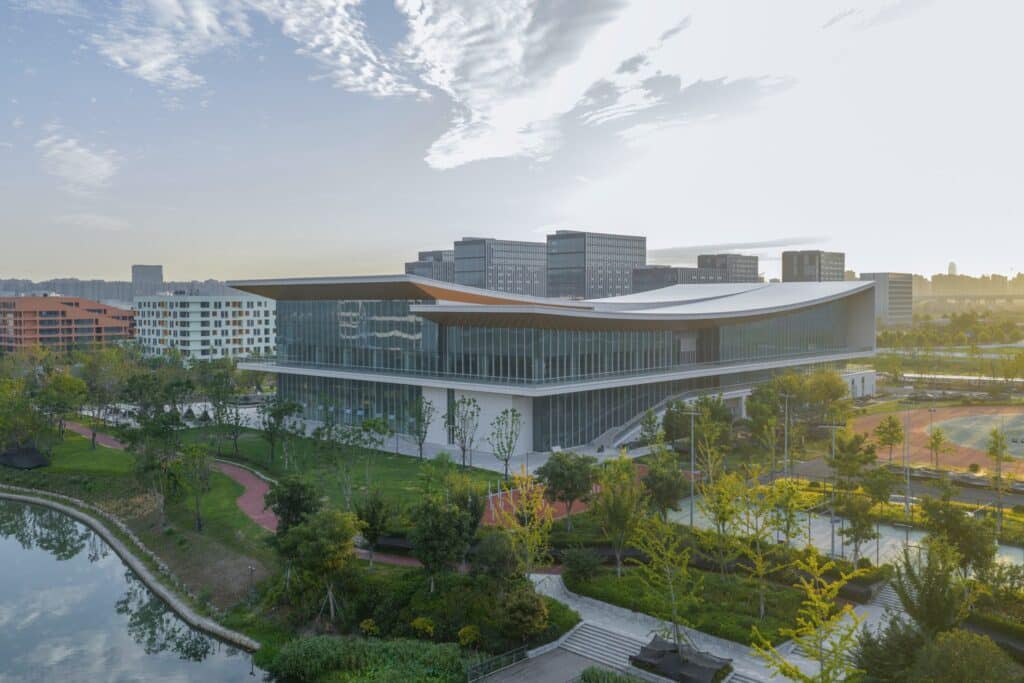 Modular academic buildings at West Lake University featuring linear structures with distinct facade patterns and colors.