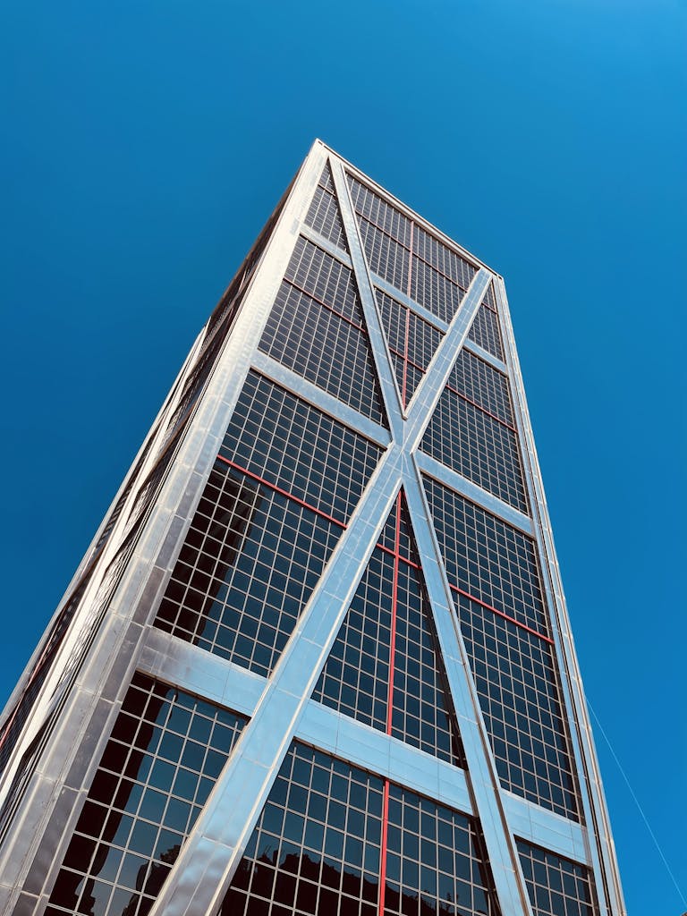 Low angle shot of the iconic Puerta de Europa Tower in Madrid against a clear blue sky.