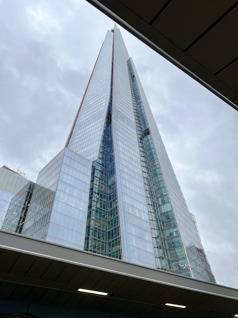 Low angle view of The Shard in London, showcasing its sleek, modern design against the sky.