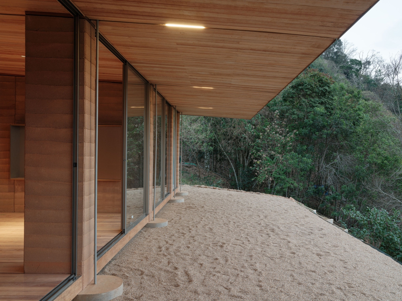 Compressed earth wall in the Piracaia Eco-Village houses, showing the traditional construction technique.