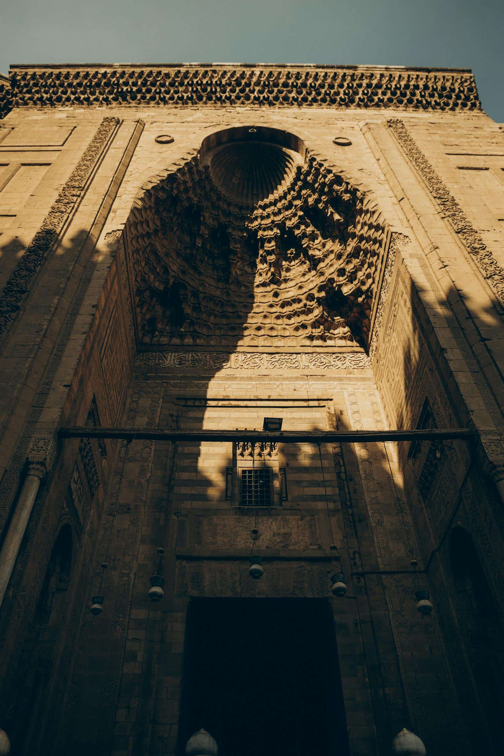 Stunning architectural details of Sultan Hassan Mosque entrance in Cairo, Egypt.