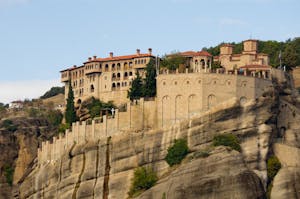 Stunning view of a historic monastery perched atop the cliffs of Meteora, Greece.