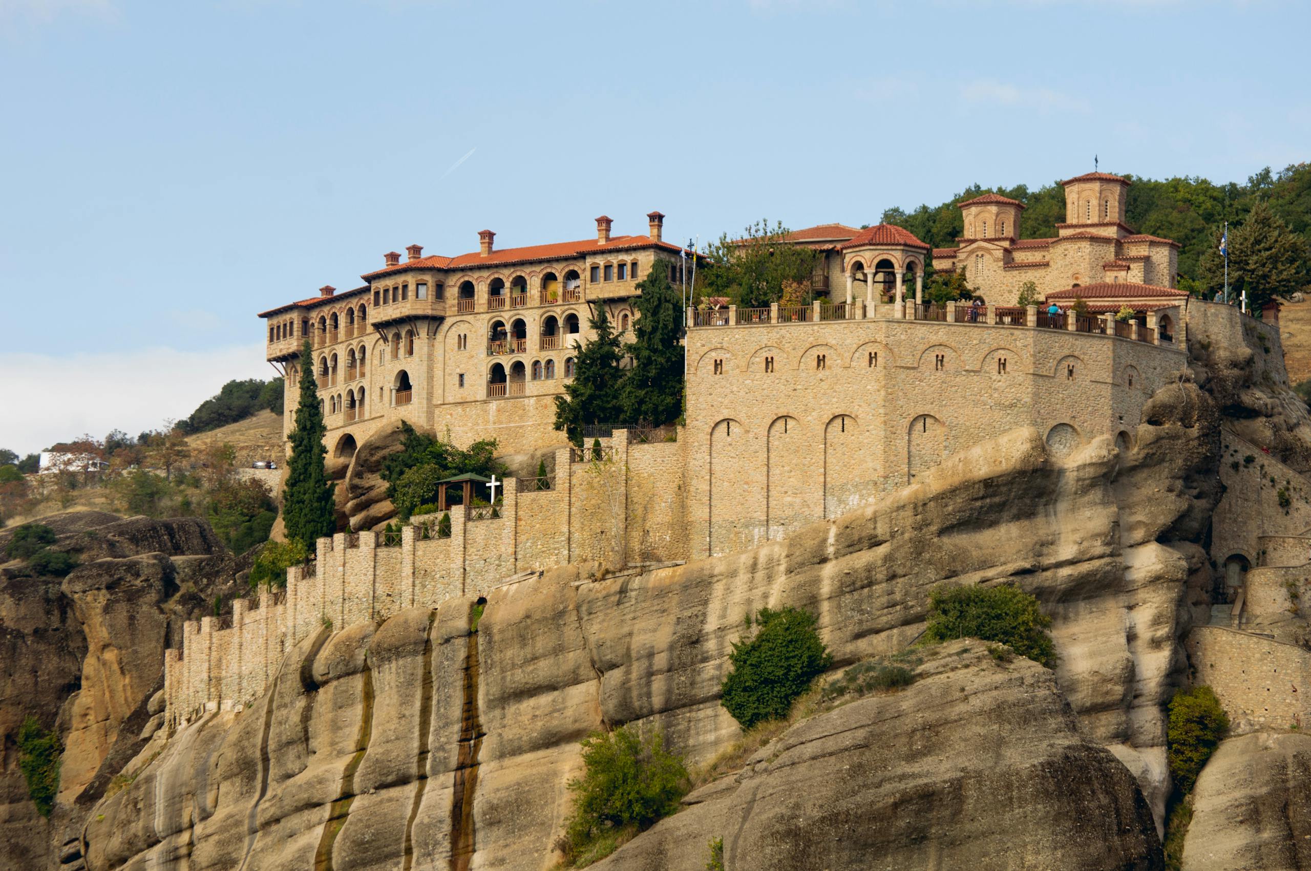 Stunning view of a historic monastery perched atop the cliffs of Meteora, Greece.