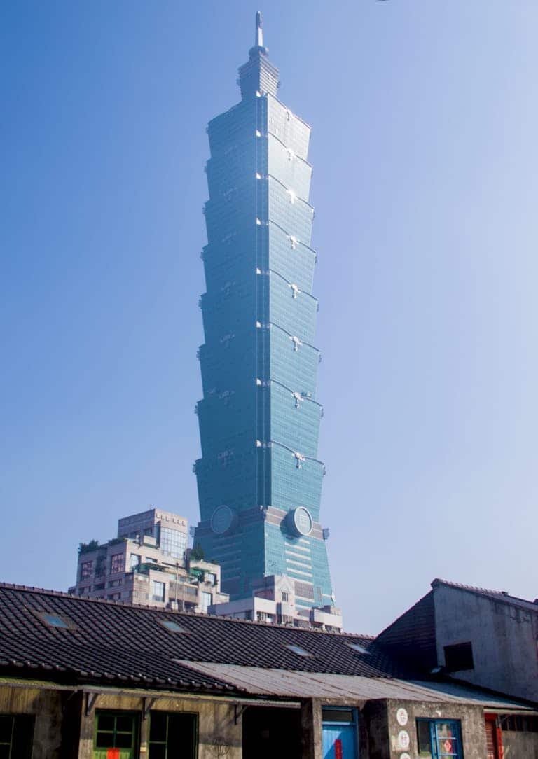 View of Taipei 101 skyscraper against a clear blue sky, showcasing its modern architecture.