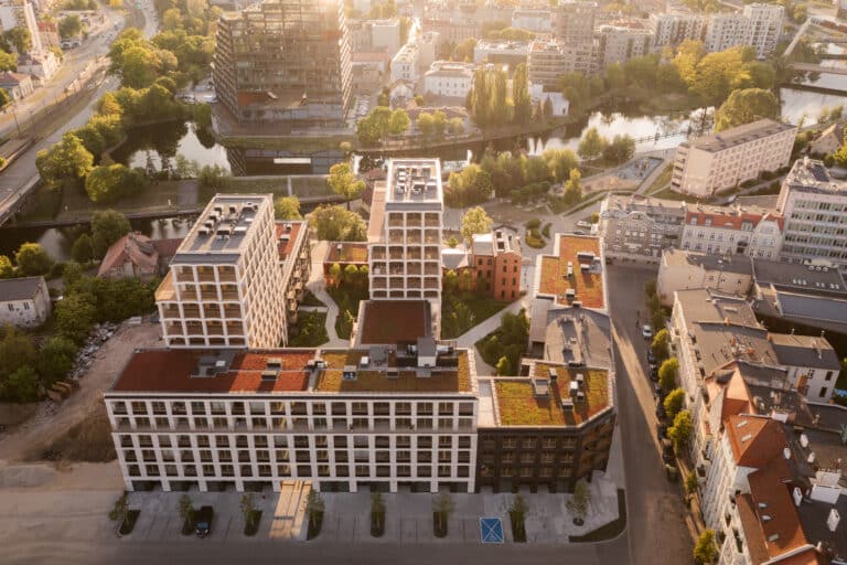 Architectural visualization of the New Port (Nowy Port) redevelopment in Bydgoszcz, designed by BBGK Architekci, showing mixed use waterfront buildings, public promenades, and integrated urban landscape.