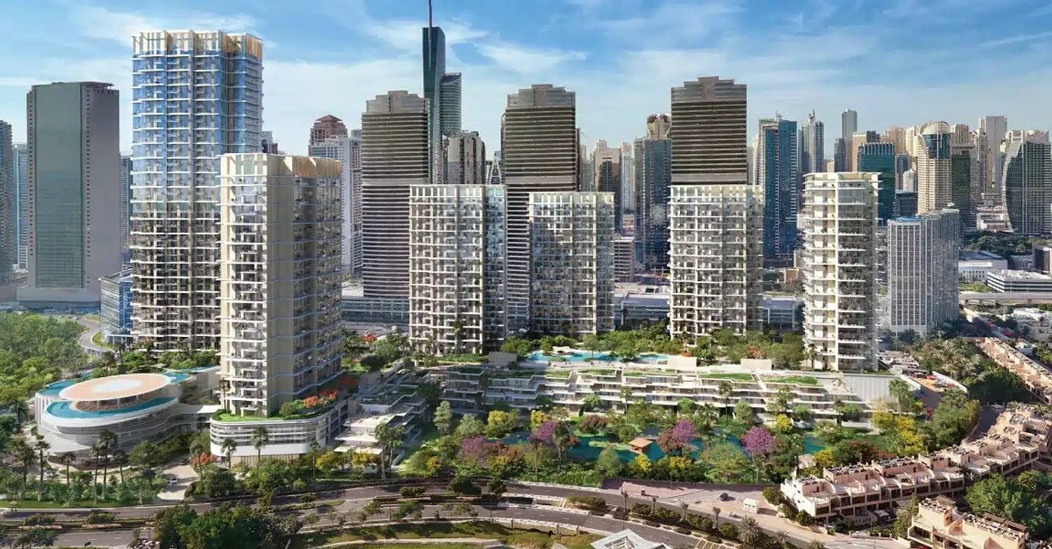 Aerial view of the Serenia District in Jumeirah Islands, Dubai, featuring six residential towers surrounded by landscaped greenery and pools, set against the city skyline.