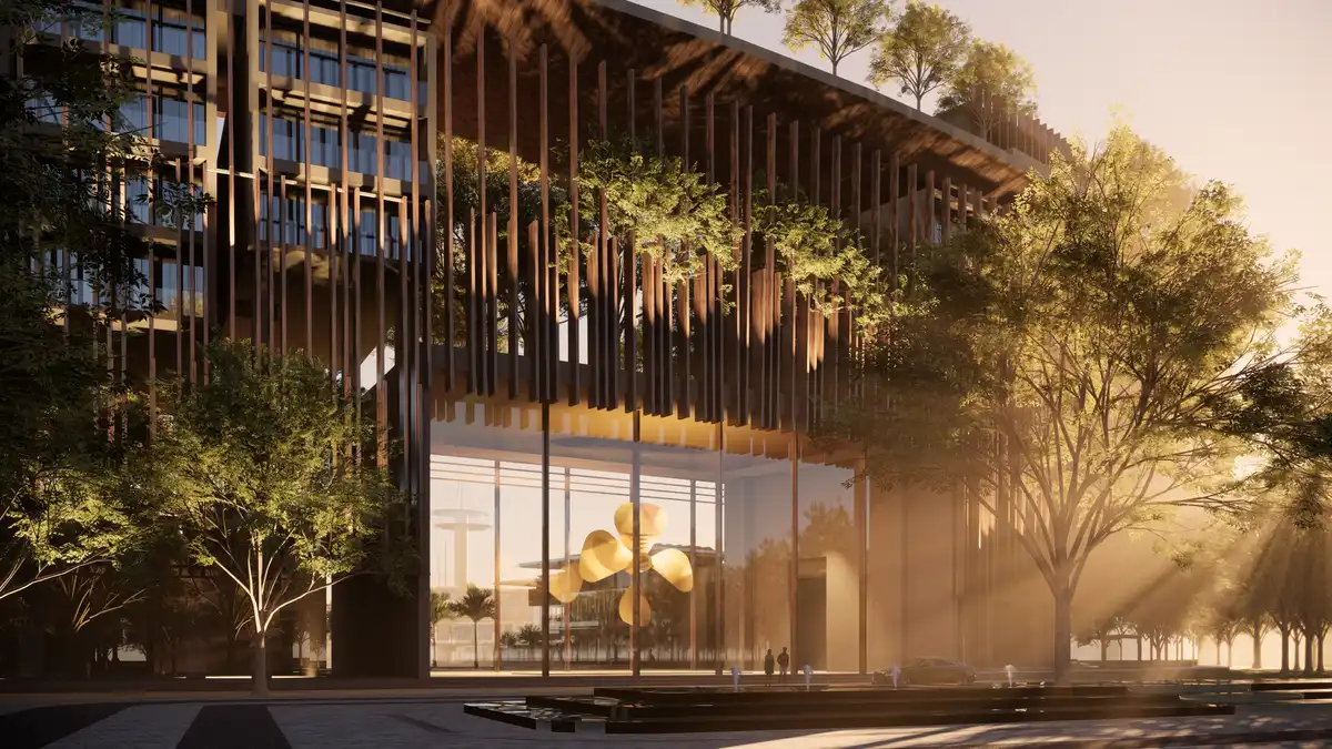 Modern office building facade with vertical wooden slats, integrated greenery, and large glass entrance at sunset, featuring a sculptural golden installation inside.