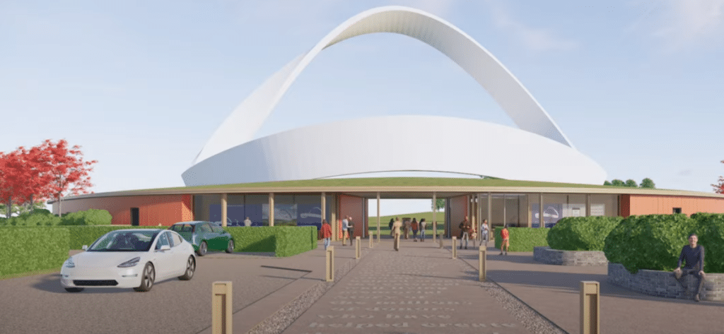 A conceptual rendering of the Eternal Wall of Answered Prayer, showing its sweeping M&ouml;bius form rising above a landscaped green field with visitors walking and gathering.
