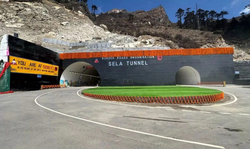 Sela Tunnel entrance in the Indian Himalayas, a key component of India&rsquo;s Border Infrastructure project, featuring festive decorations and signage by the Border Roads Organisation (BRO).