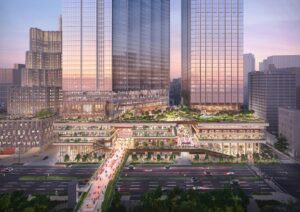 Aerial rendering of the Tokyo Cross Park development at dusk, showcasing two glass-clad towers above a multi-level public podium with green terraces and pedestrian bridges over a major road.