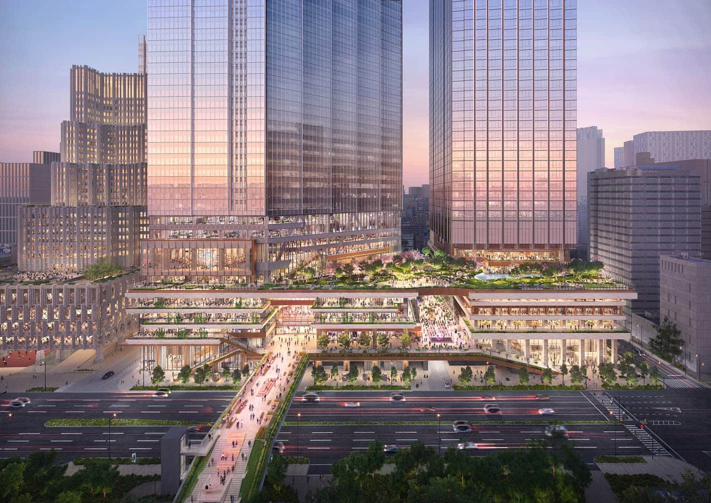 Aerial rendering of the Tokyo Cross Park development at dusk, showcasing two glass-clad towers above a multi-level public podium with green terraces and pedestrian bridges over a major road.