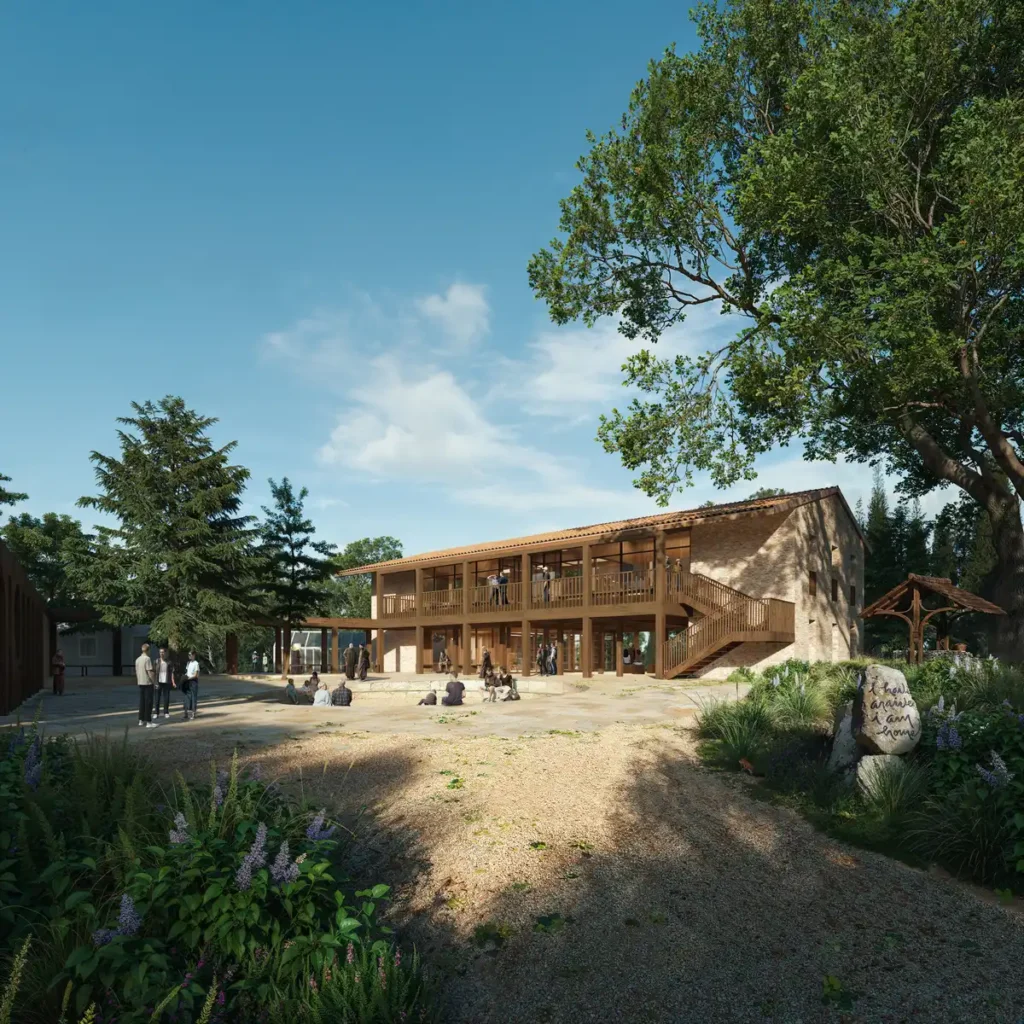 Rendering of the Plum Village architectural project&rsquo;s new guest house in Dordogne, France, featuring timber balconies, stone walls, and integration with surrounding trees under a clear sky.