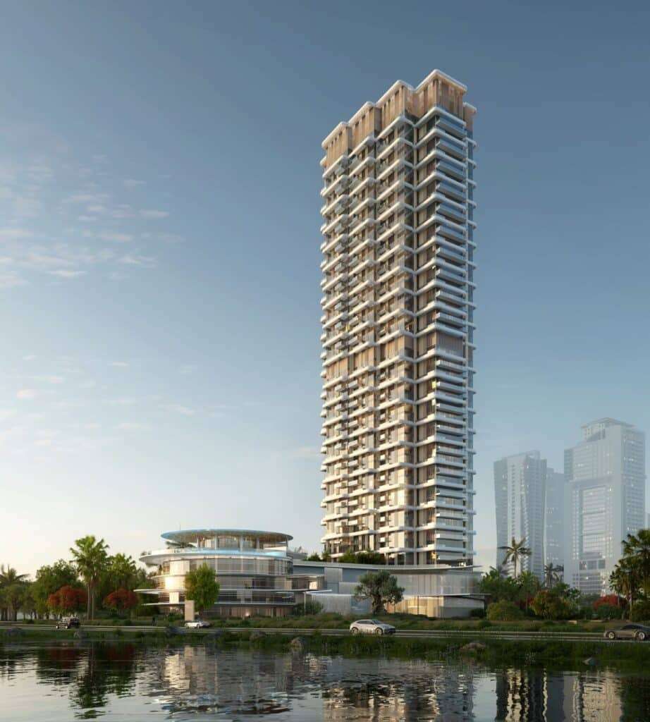 Rendering of the West Residence tower in Jumeirah Islands, Dubai, showcasing its 46-storey height with cantilevered balconies and a low-rise circular amenity building beside a water feature.