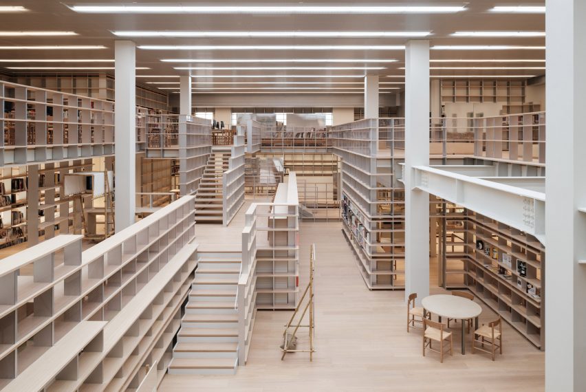 Espace Gabrielle Chanel multi-level library interior with integrated staircases, wooden flooring, and open reading areas within Shanghai&rsquo;s Power Station of Art.