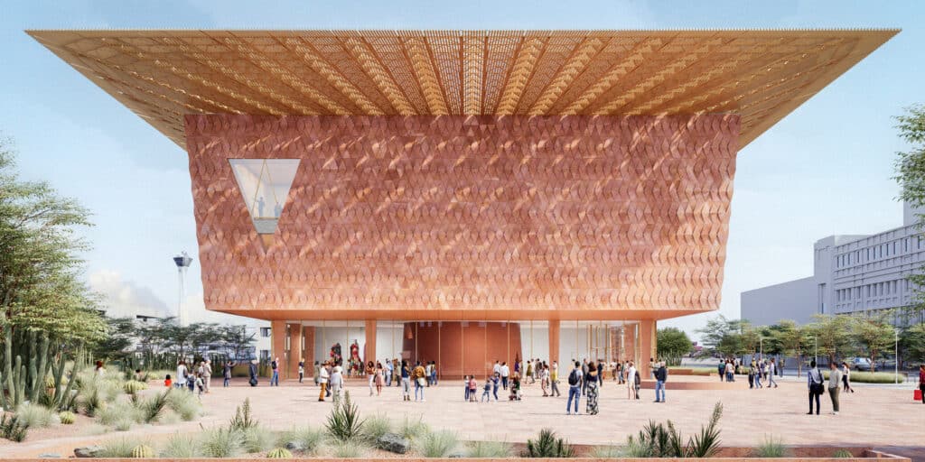 Rendering of the Las Vegas Museum of Art&rsquo;s main entrance, featuring a textured copper facade and expansive wooden canopy over a public plaza with desert landscaping.