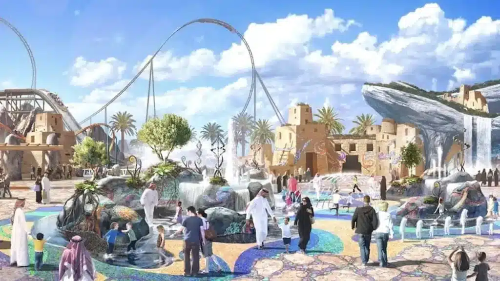 A conceptual rendering of a desert-themed entertainment plaza in Qiddiya, Saudi Arabia, featuring roller coasters, water fountains, and visitors in traditional attire under a bright sky.