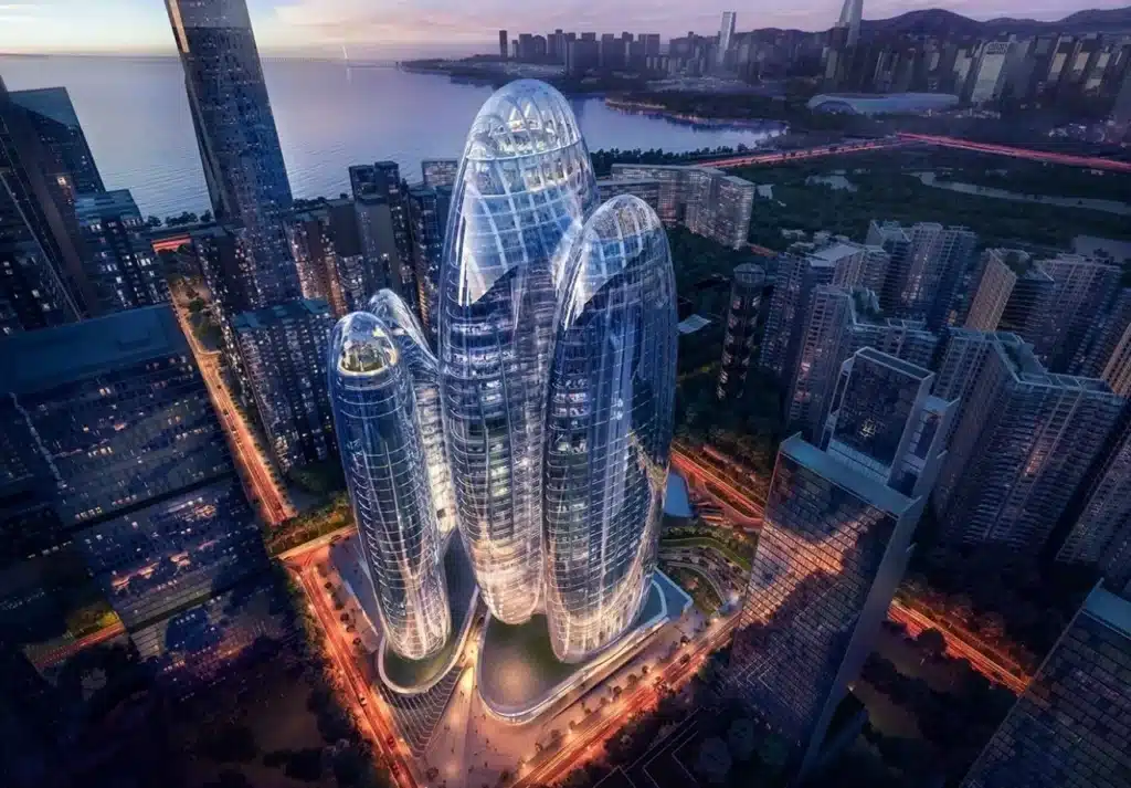 OPPO headquarters towers illuminated at dusk, showcasing their sculptural glass form against Shenzhen Bay.