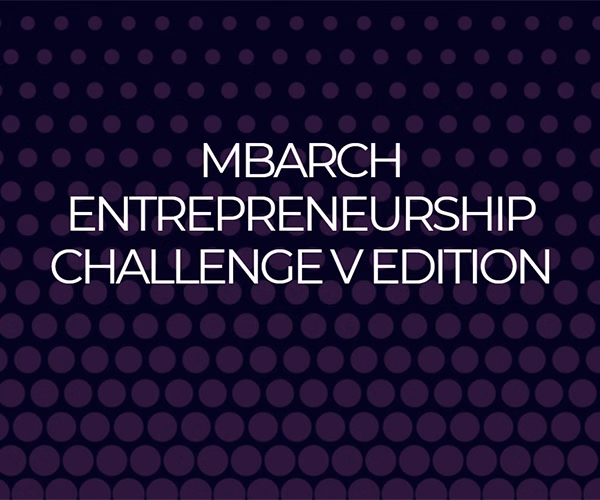 Contemporary architecture building with cubic volumes set within landscaped greenery, showing a modern residential or institutional project.