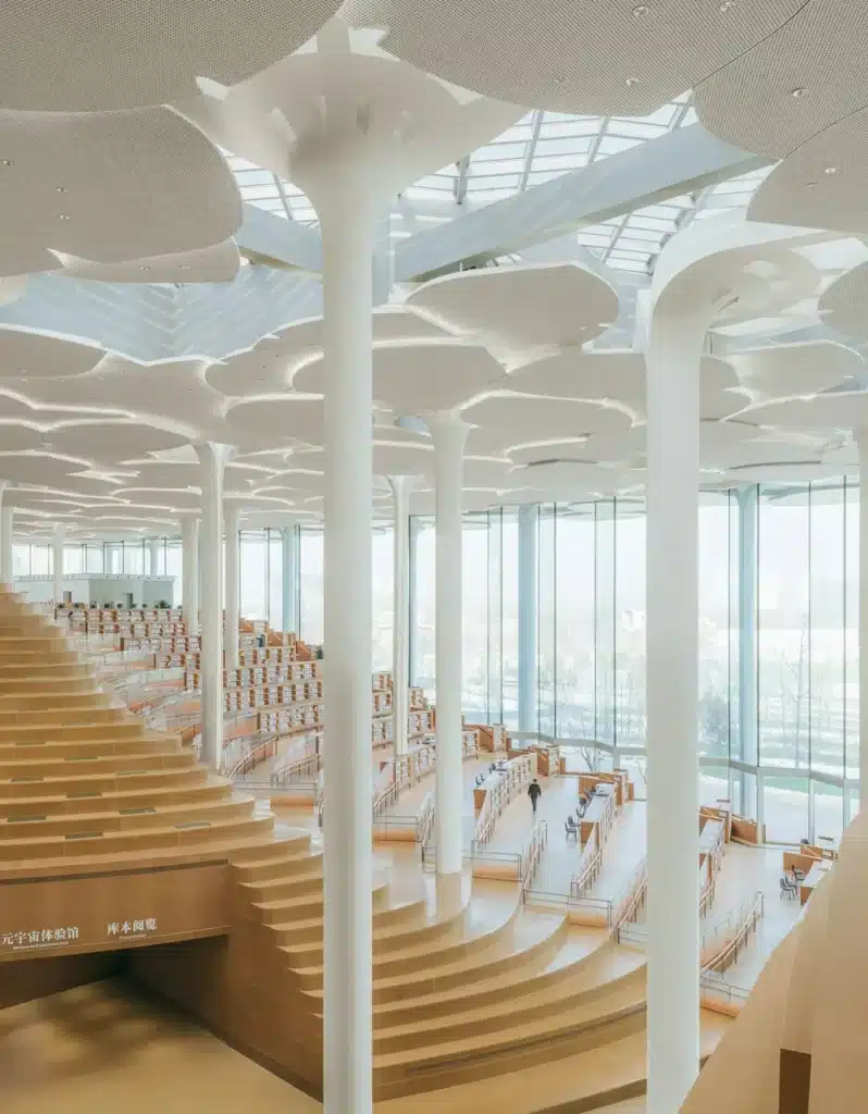 Beijing Library interior with sculptural white columns and layered canopy above tiered reading terraces.