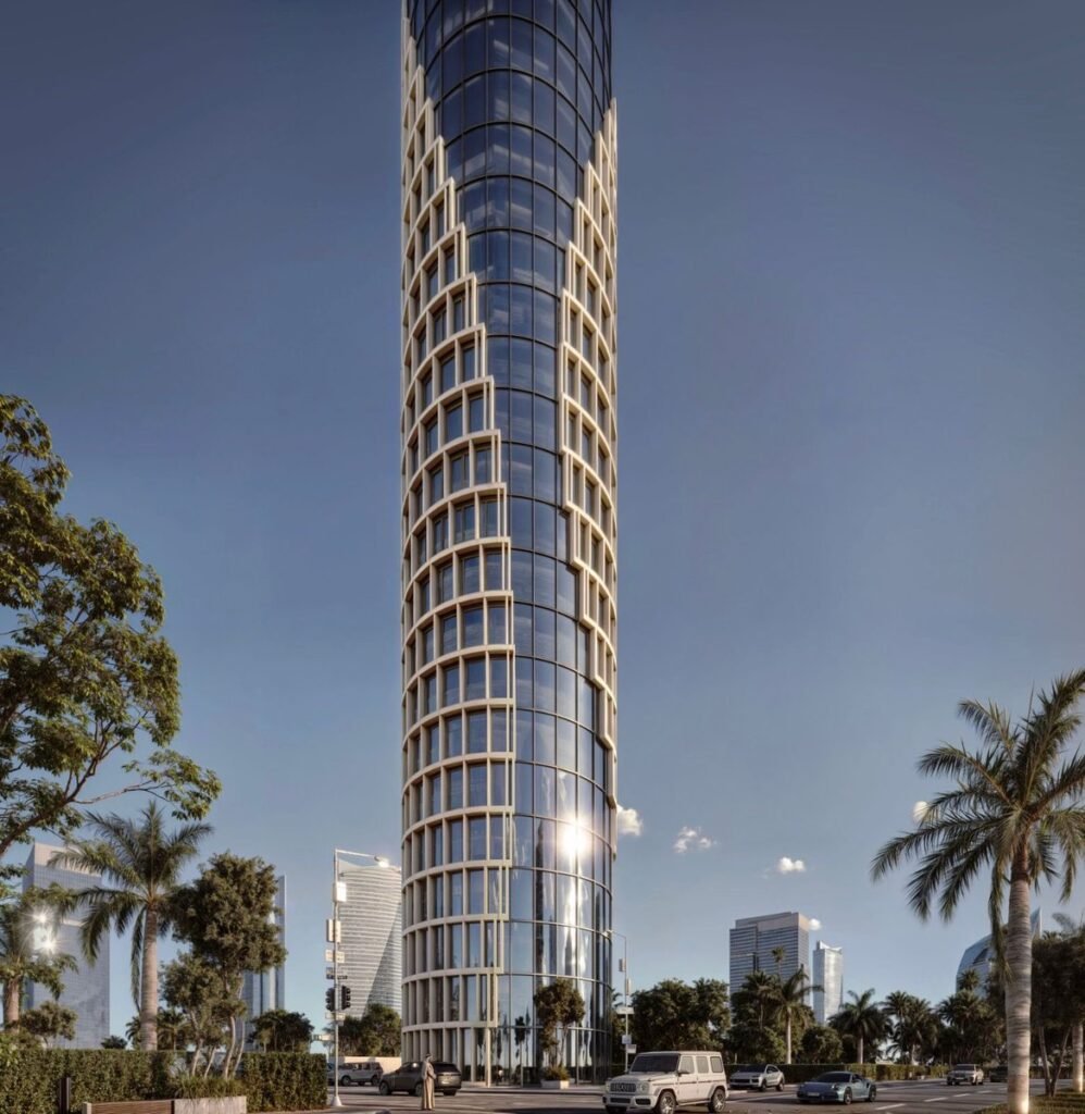Alt: A modern cylindrical tower featuring a full glass façade and a thin white grid, lending a sense of dynamism and elegance.