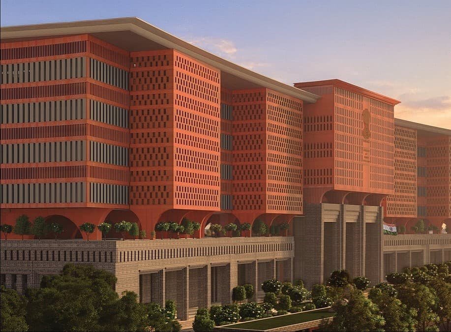 Monumental facade in perforated red brick with vertical apertures emphasizing architectural mass and strength.