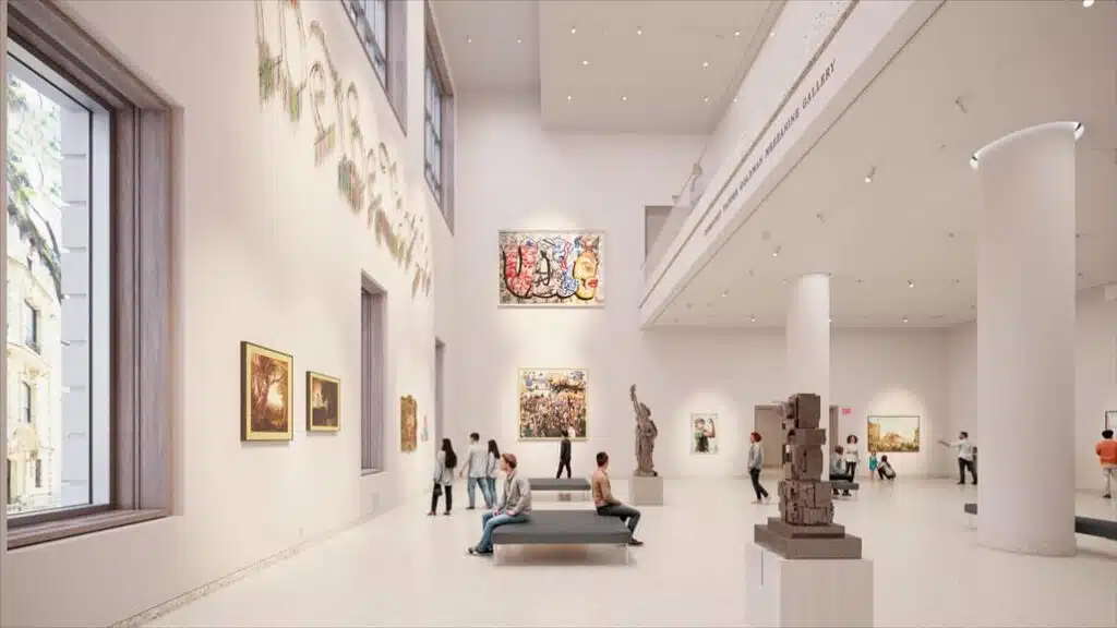 Spacious art gallery in the Tang Wing, featuring high ceilings, white columns, and natural windows, displaying diverse artworks within modern architectural design.