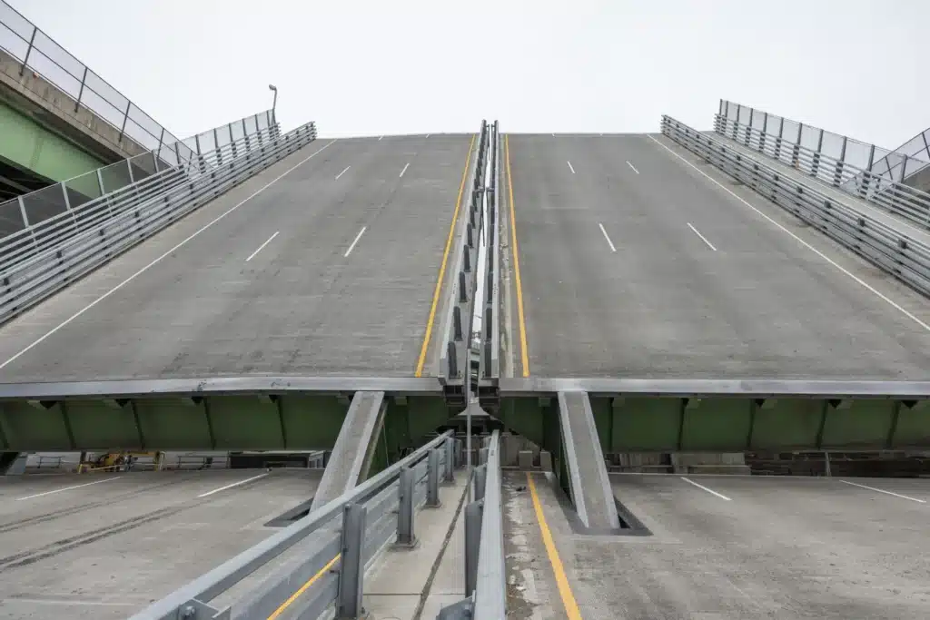 Dual-span bascule bridge design in the Bronx, showcasing the central lifting gap between roadways — part of a $232 million modern infrastructure project serving vehicular and marine traffic.