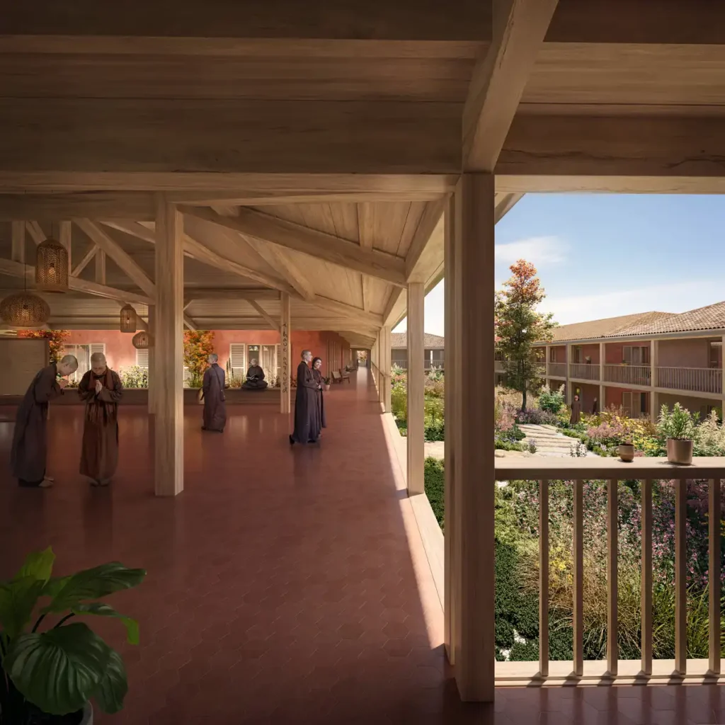 Interior rendering of the Plum Village architectural project&rsquo;s new nunnery in Dordogne, France, showing a timber framed veranda with monks in contemplative practice and garden views.
