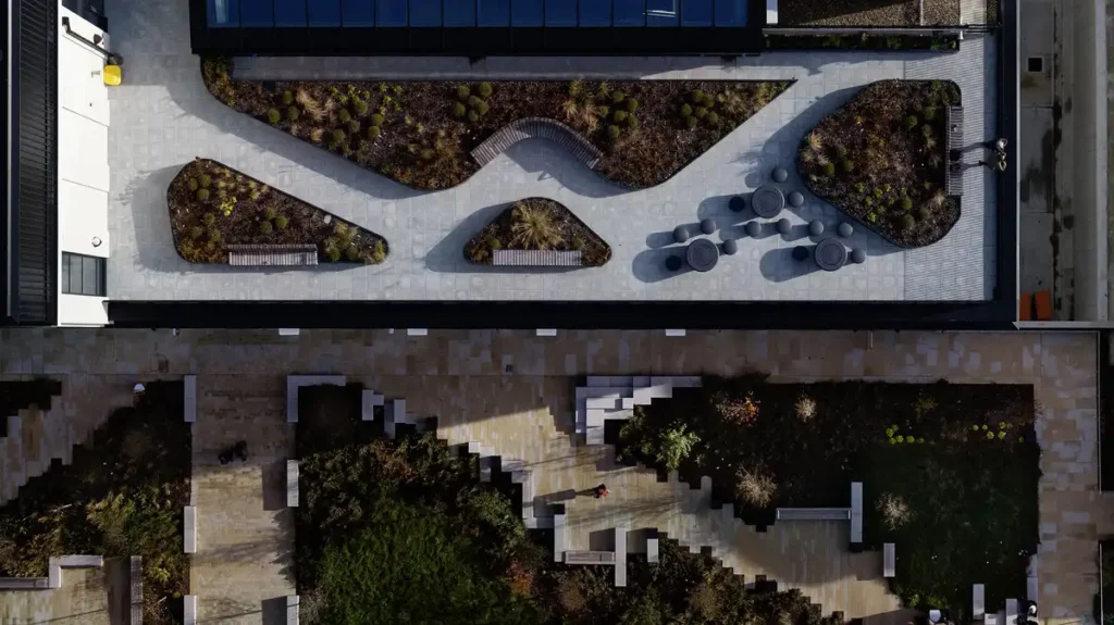 An aerial view of a rooftop garden at Sheffield Hallam University&rsquo;s Langsett, Redmires and Strines complex, featuring curved walkways and irregular planting beds as part of its academic architecture project.