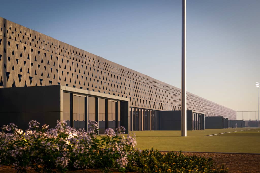 Close-up of perforated concrete wall with triangular patterns at House of Nassr, adjacent to training field.
