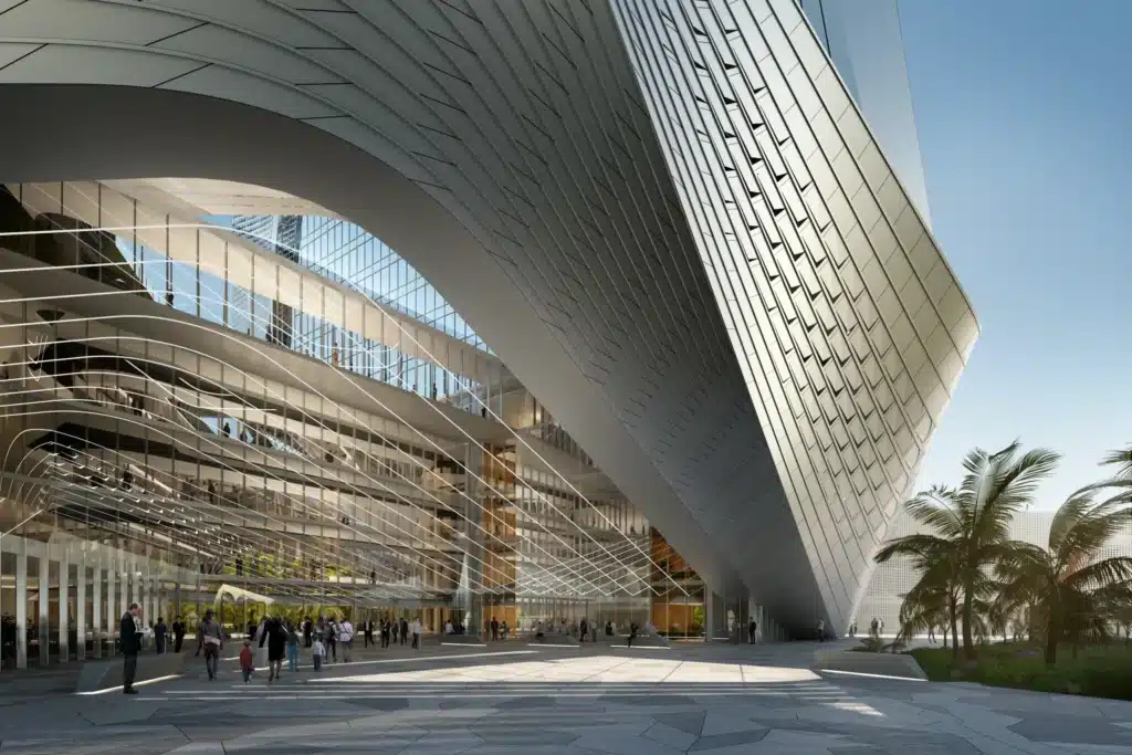 Detailed fa&ccedil;ade with curved panels subtly shading the open public gathering area for pedestrians below.