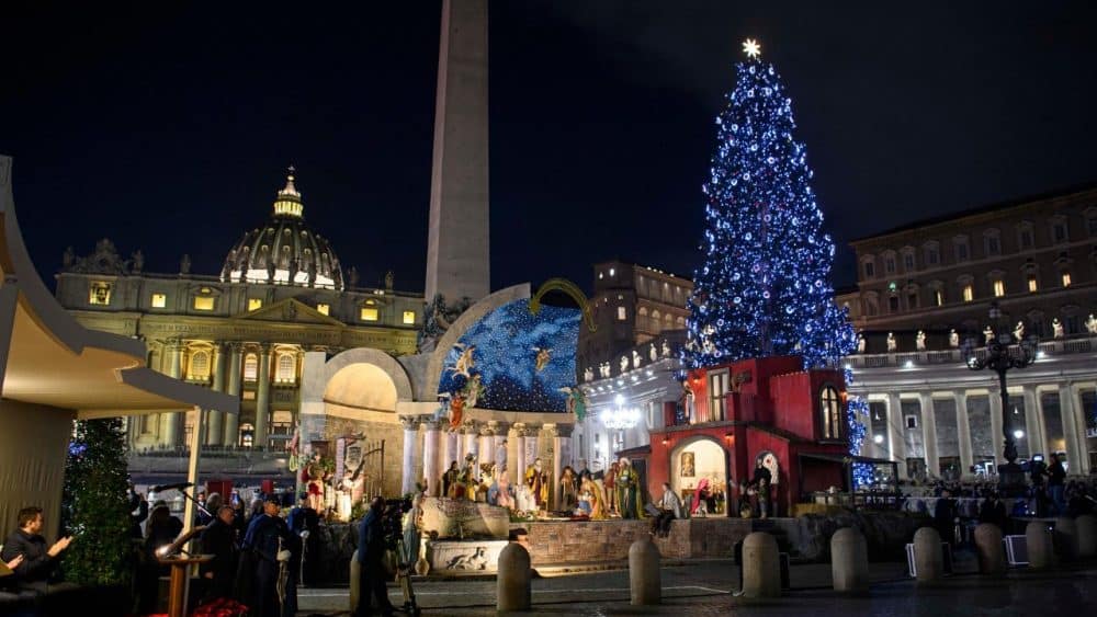 Architectural integration of Christmas tree and Nativity scene at St. Peter&rsquo;s Square, blending temporary installations with Baroque heritage at night.
