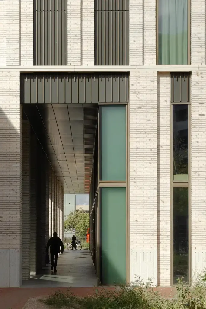 The deep, recessed entrance creates a sheltered path for pedestrians, offering a sense of calm and organized movement.