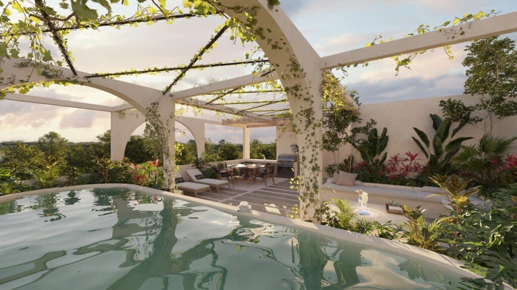 Rooftop terrace at Vernal Tulum featuring biophilic architecture with infinity pool, pergola, and tropical plants at sunset.