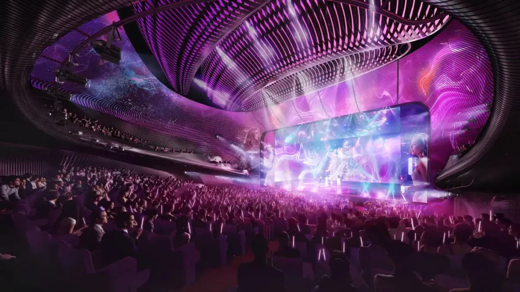 Rendered view of the Central Yards Hong Kong theatre auditorium with a large audience, immersive purple and pink lighting, and a curved digital screen displaying performers on stage.