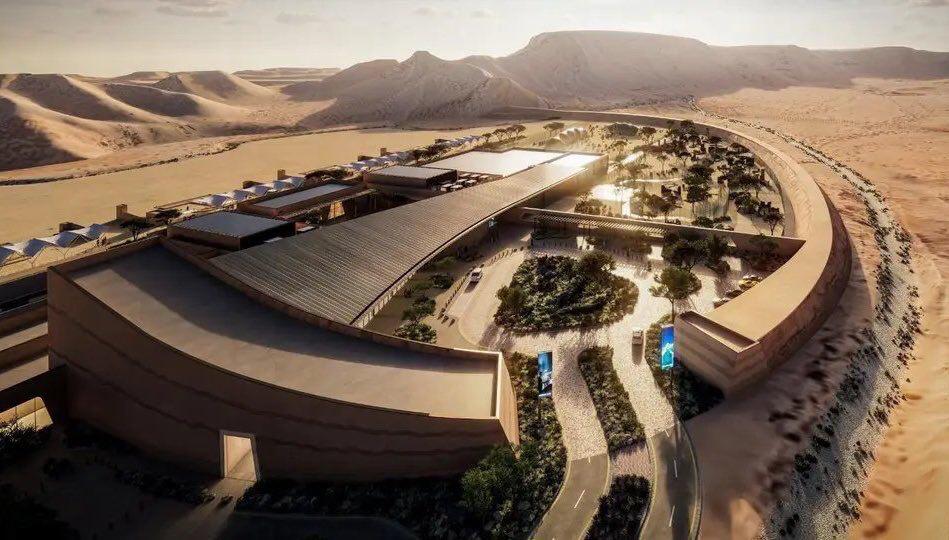 Aerial rendering of a modern event infrastructure complex nestled in the Saudi desert, featuring curved architectural forms and integrated green spaces for experiential urban development.