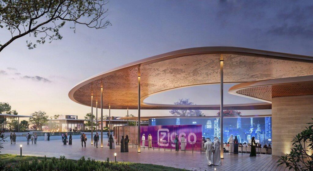 Rendering of Ajdan Island&rsquo;s evening plaza in Khobar, featuring a large curved canopy with perforated pattern, illuminated walkways, digital display wall, and visitors in traditional attire under twilight sky.