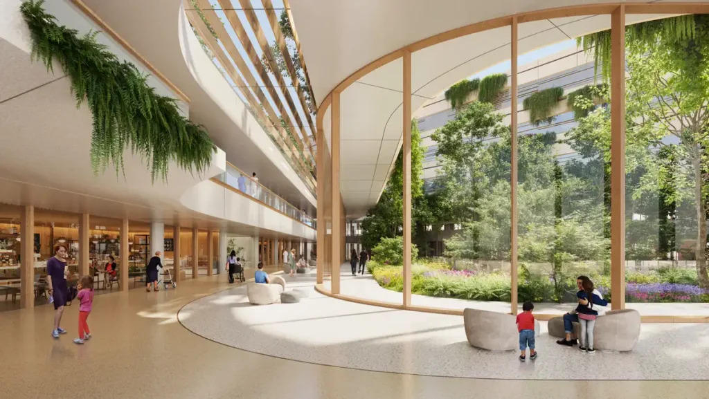 Interior corridor of Malpensa Hospital by Zaha Hadid, showing a flowing design with greenery and glass walls connecting the medical space to the outdoor garden.