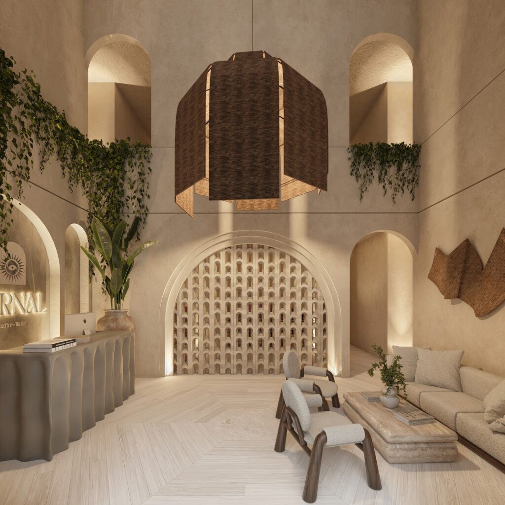 Interior lobby of Vernal Tulum showcasing biophilic architecture with arched openings, vertical gardens, and warm ambient lighting.