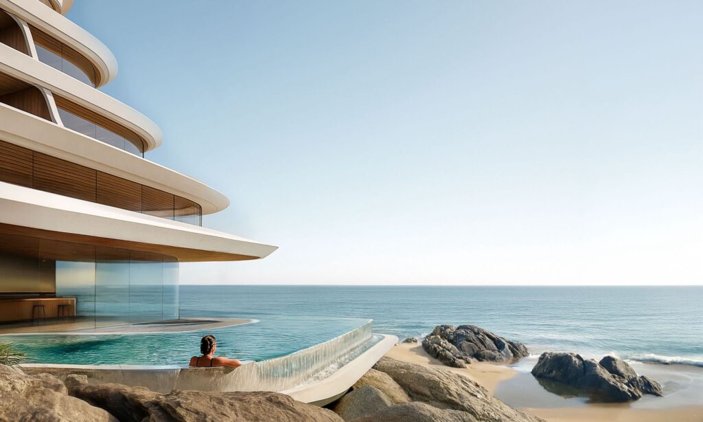 NOT A HOTEL Okinawa guest relaxing in an infinity pool overlooking the Pacific, with layered balconies and coastal rocks in view.